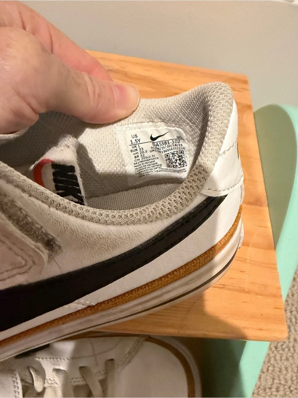 Nike Kids White Sneakers with Black Swoosh and Tan Stripe